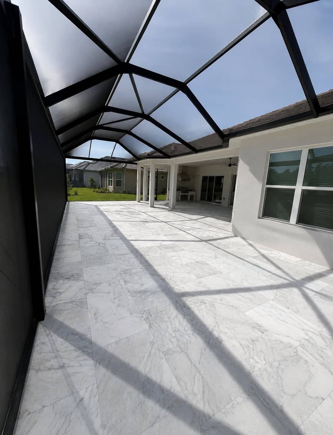 Screened Lanai with Travertine-Look Tile & Outdoor Kitchen